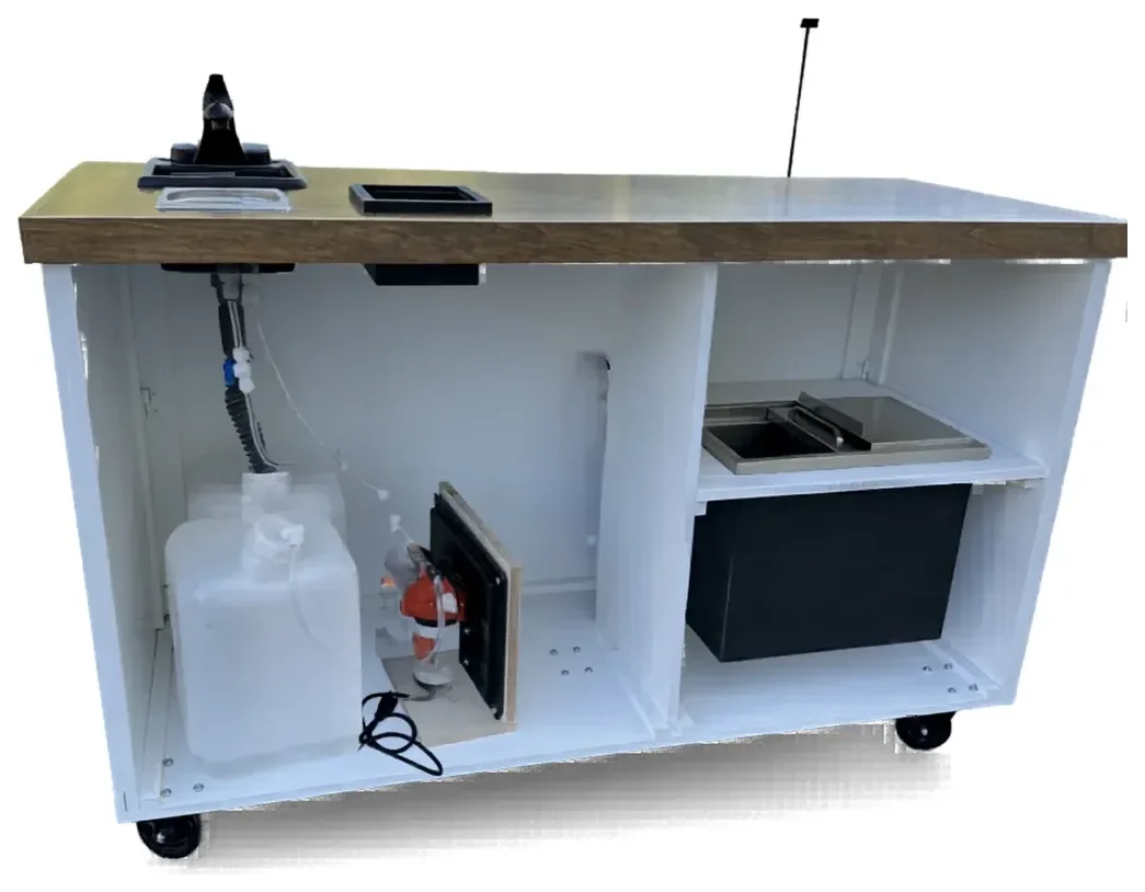 The back of a plumbed RidgeCraft cart, showing the fresh water tank, the mounted pump, the tubing run, the sink and the grey water tank