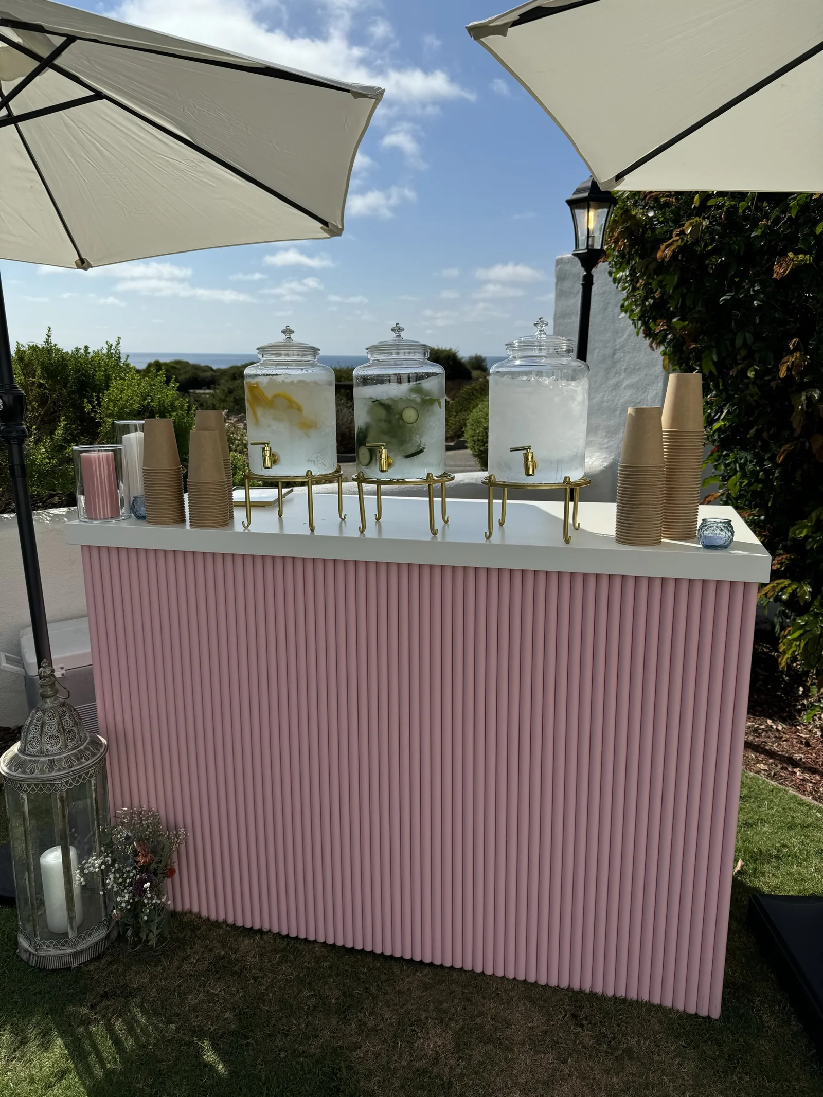 The pink corrugated bar at dusk under string lights on an outdoor patio