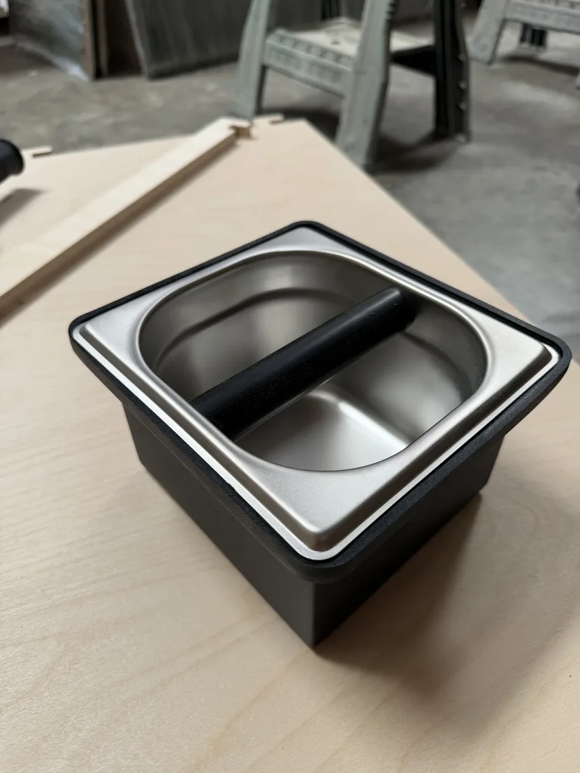 A stainless steel espresso knock box insert